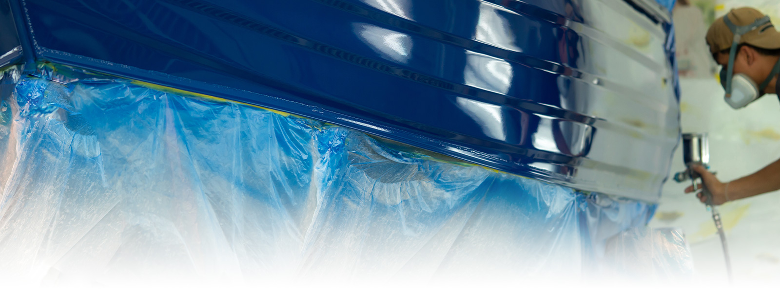 Photo of staff gel painting the body of the boat Photo of staff gel painting the body of the boat